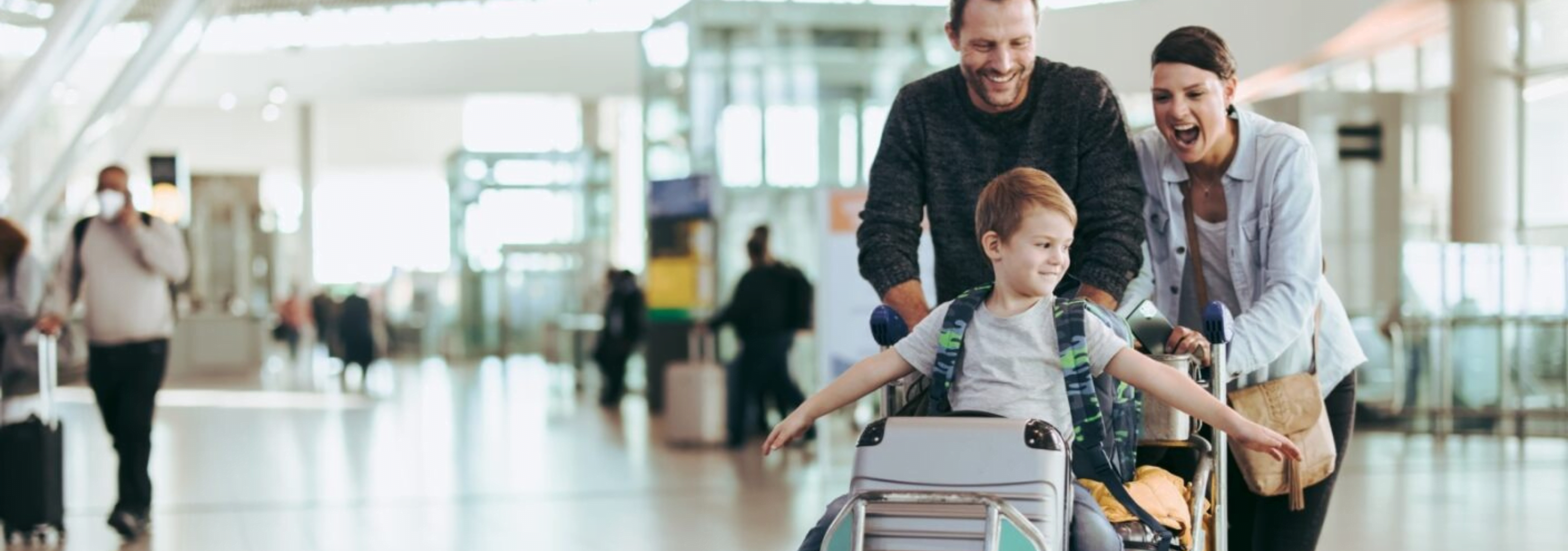 Family in an airport, preparing to enjoy themselves on a holiday.